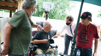 PM Trudeau chats with a man in a wheelchair