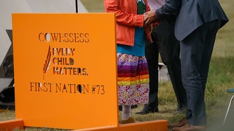An orange sign that reads “Cowessess every child matters First Nation #73”