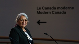 Ms. Mary Simon smiles at a podium