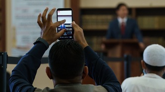 A man takes a photo of PM Trudeau