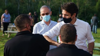 PM Trudeau bumps elbows with a man