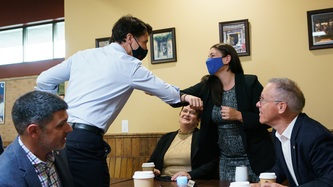 PM Trudeau bumps elbows with a woman