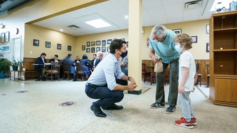 PM Trudeau kneels to talk to a young boy