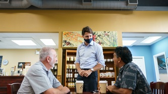 PM Trudeau speaks with two men
