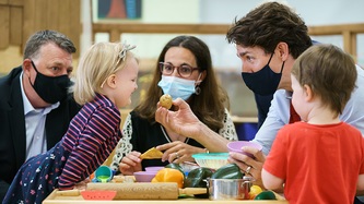 PM Trudeau plays with children at a table