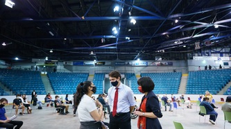 PM Trudeau and Minister Petitpas-Taylor speak with a woman