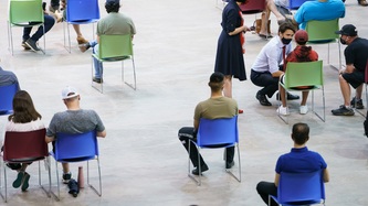 PM Trudeau kneels to talk to a young man