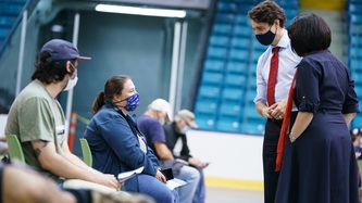 PM Trudeau and Minister Petitpas-Taylor speak with a man