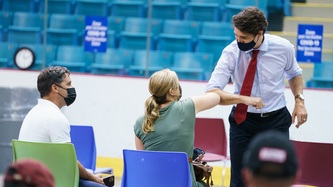 PM Trudeau bumps elbows with a woman