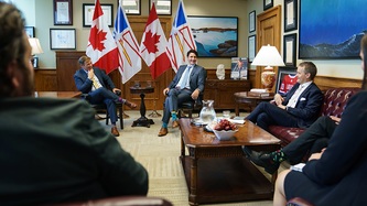 Premier Furey and PM Trudeau look to Minister Minister O’Regan Jr, all sitting in an office
