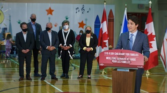 PM Trudeau stands at a podium in a gymnasium
