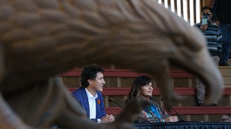 Prime Minister Justin Trudeau and Tk’emlúps te Secwe̓pemc Chief Rosanne Casimir sit facing mics