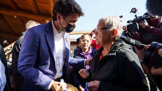 Prime Minister Justin Trudeau greets a woman in a crowd
