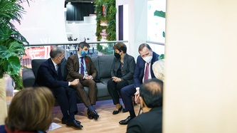 Minister Steven Guilbeault and others sit on a couch