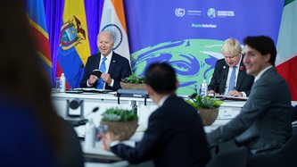 President Joe Biden and PM Boris Johnson are in focus as PM Justin Trudeau looks on