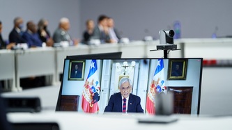 A video screen is in view in a meeting room