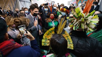 Prime Minister Justin Trudeau looks at a crowd of people and cameras