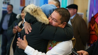 Minister Patty Hajdu gives a hug to Chief Wally Burns