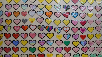 A wall collage of thoughtful messages on heart-shaped cards