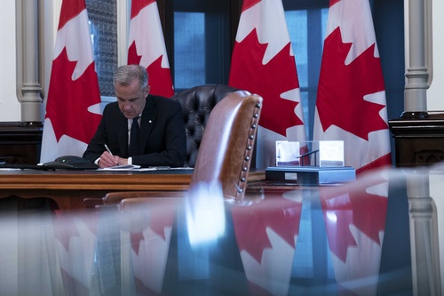 Prime Minister Mark Carney is sitting in his office and speaking on the phone with Prime Minister of Spain Pedro Sánchez.