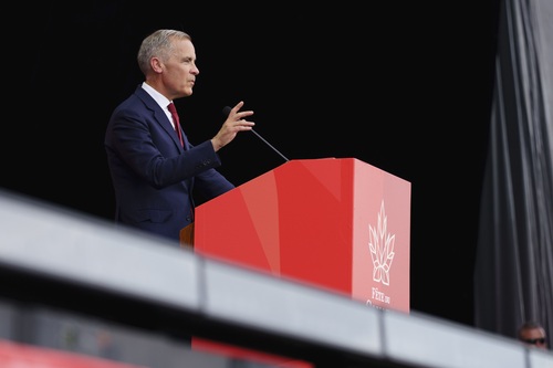 Prime Minister Mark Carney delivers remarks on stage at the Canada Day national noon ceremony.