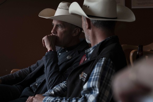 Prime Minister Carney sitting with a man at the Calgary Stampede.