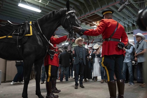Prime Minister Carney speaking with RCMP officers at the Calgary Stampede.