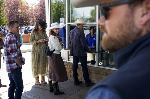 Prime Minister Carney at an outside service counter at the Calgary Stampede.