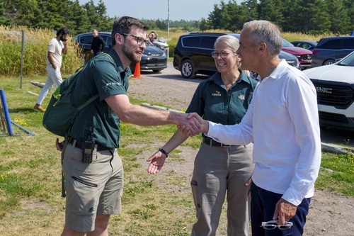 Prime Minister Mark Carney visits Prince Edward Island National Park and shakes hands with Parks Canada employees.