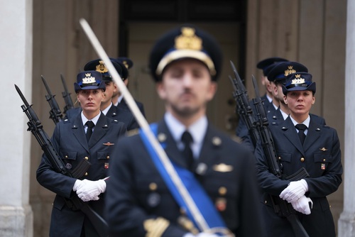 A group of guards are standing on the grounds of Chigi Palace. 