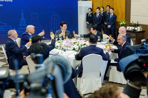 Prime Minister Mark Carney and other world leaders raise their glasses for a toast during a working dinner hosted by the P...