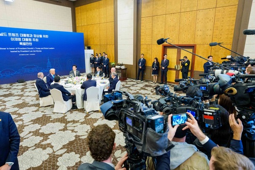 Prime Minister Mark Carney and other world leaders engage in a discussion during a working dinner hosted by the President ...
