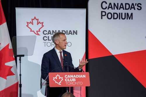 Prime Minister Mark Carney stands at a podium and delivers remarks related to Budget 2025 at the Canadian Club Toronto.