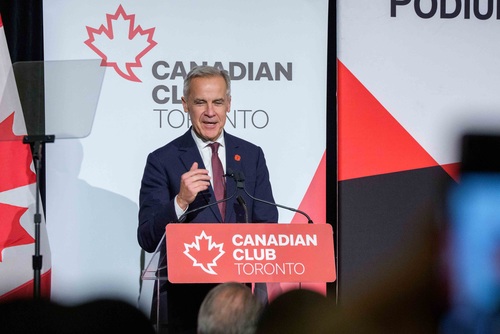 Prime Minister Mark Carney stands at a podium and delivers remarks related to Budget 2025 at the Canadian Club Toronto.