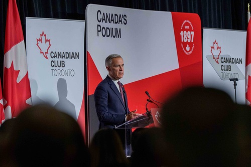 Prime Minister Mark Carney stands at a podium and delivers remarks related to Budget 2025 at the Canadian Club Toronto.