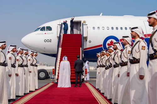 Le premier ministre Mark Carney salue la foule avant de monter à bord d’un avion au terme de sa visite au Qatar.